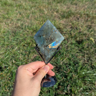 Labradorite crystal diamond on a display stand