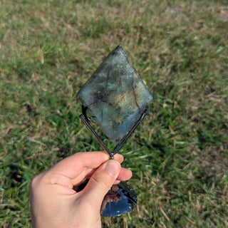 Labradorite crystal diamond on a display stand