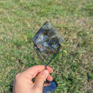 Labradorite crystal diamond on a display stand