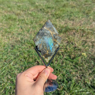 Labradorite crystal diamond on a display stand